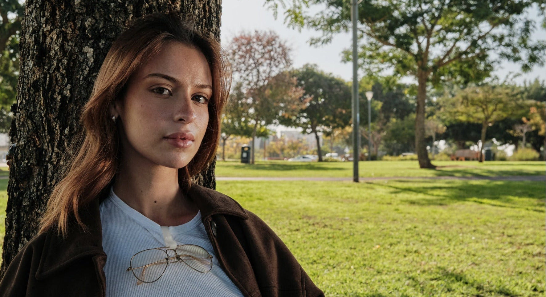 Woman sitting under a tree in a park